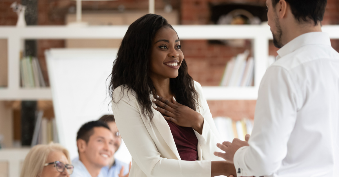 Professional woman shaking hands with her male boss