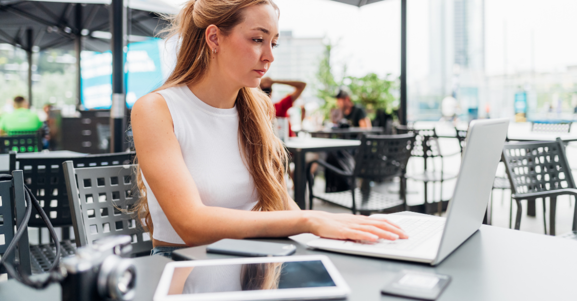 Woman working on her laptop outside