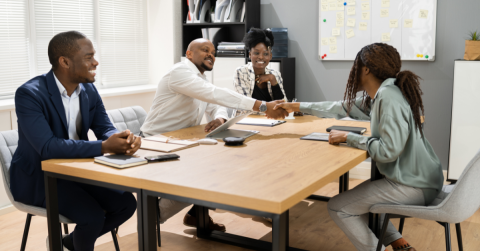 Four professionals sitting at a table having a discussion